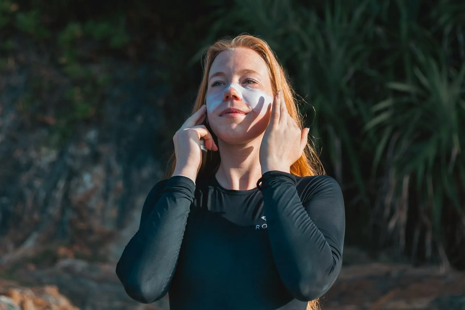 Surfer applying zinc sunscreen before going into the water